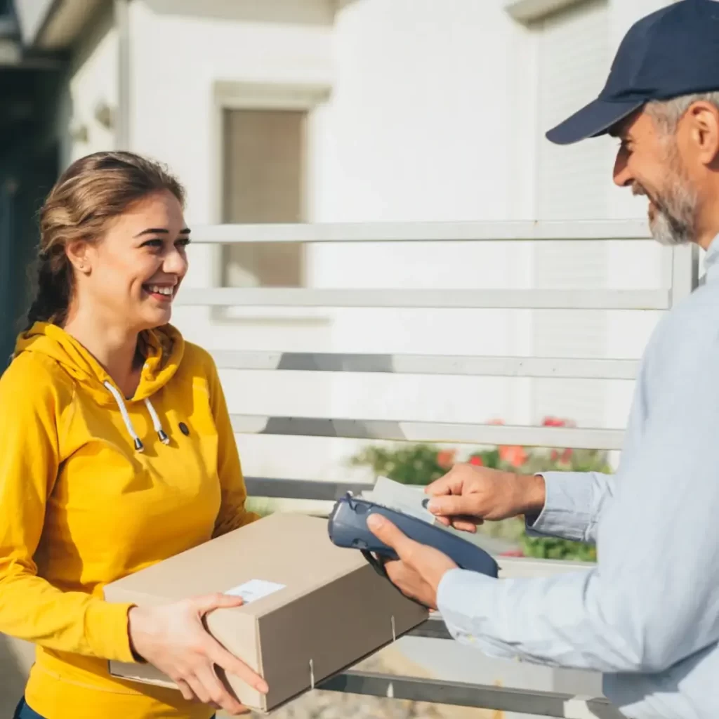 Man in a blue unifrom delivering a crowdfunding package to a women.