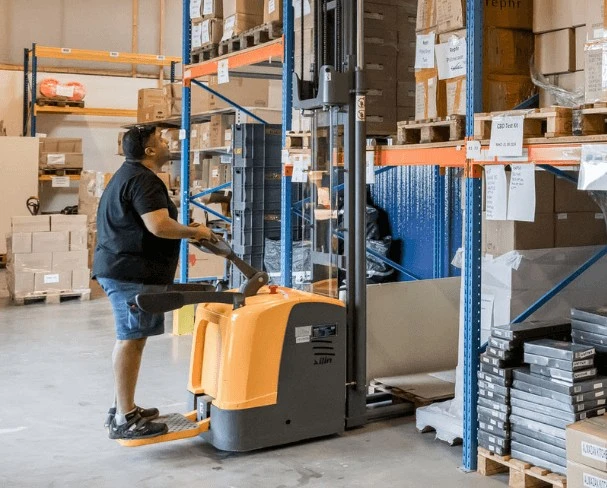 SMS Fulfillment warehouse worker preparing goods for distribution