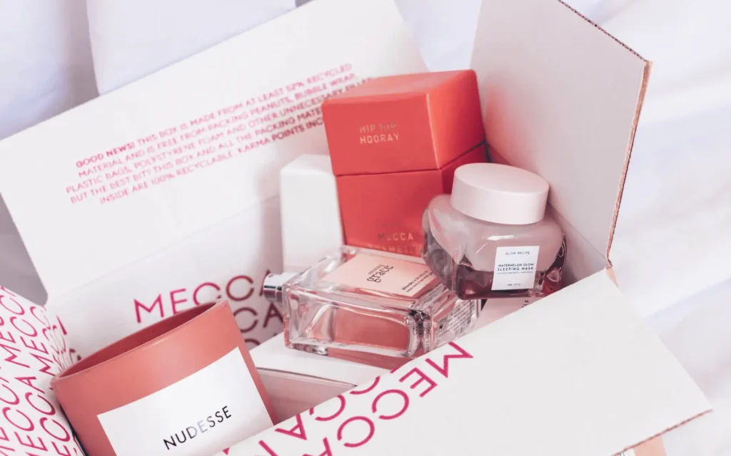 Beauty subscription box with cosmetics products in pink packages